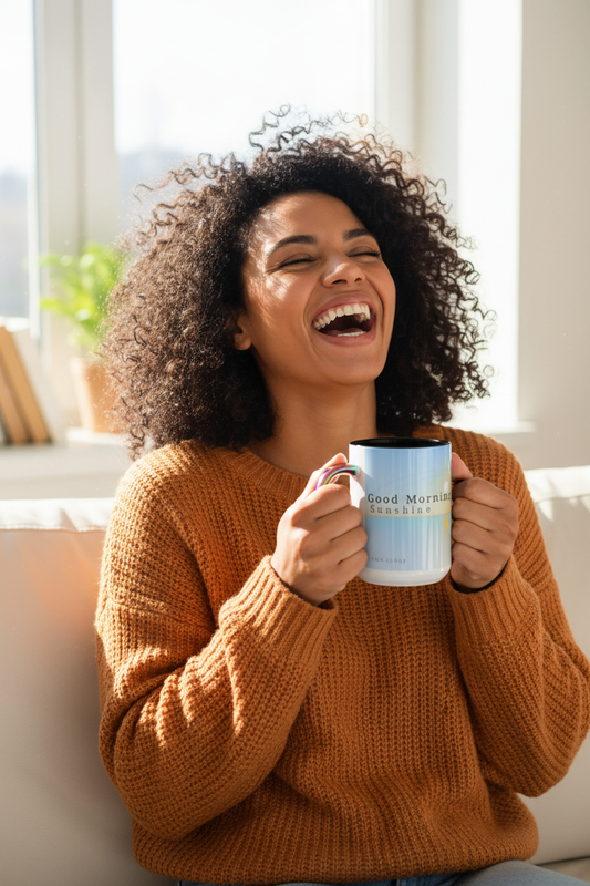 Mixed race woman laughing with accent mug on couch